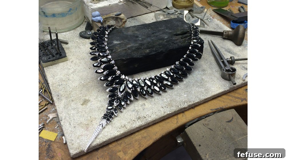Stephen Webster's artisans crafting a bespoke necklace in his London workshop, showcasing intricate detail and expert craftsmanship in jewelry transformation.