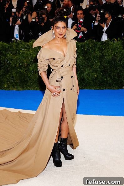 Priyanka Chopra in her iconic Ralph Lauren trench coat gown at the 2017 Met Gala, showcasing its impressive cathedral train and unique design.