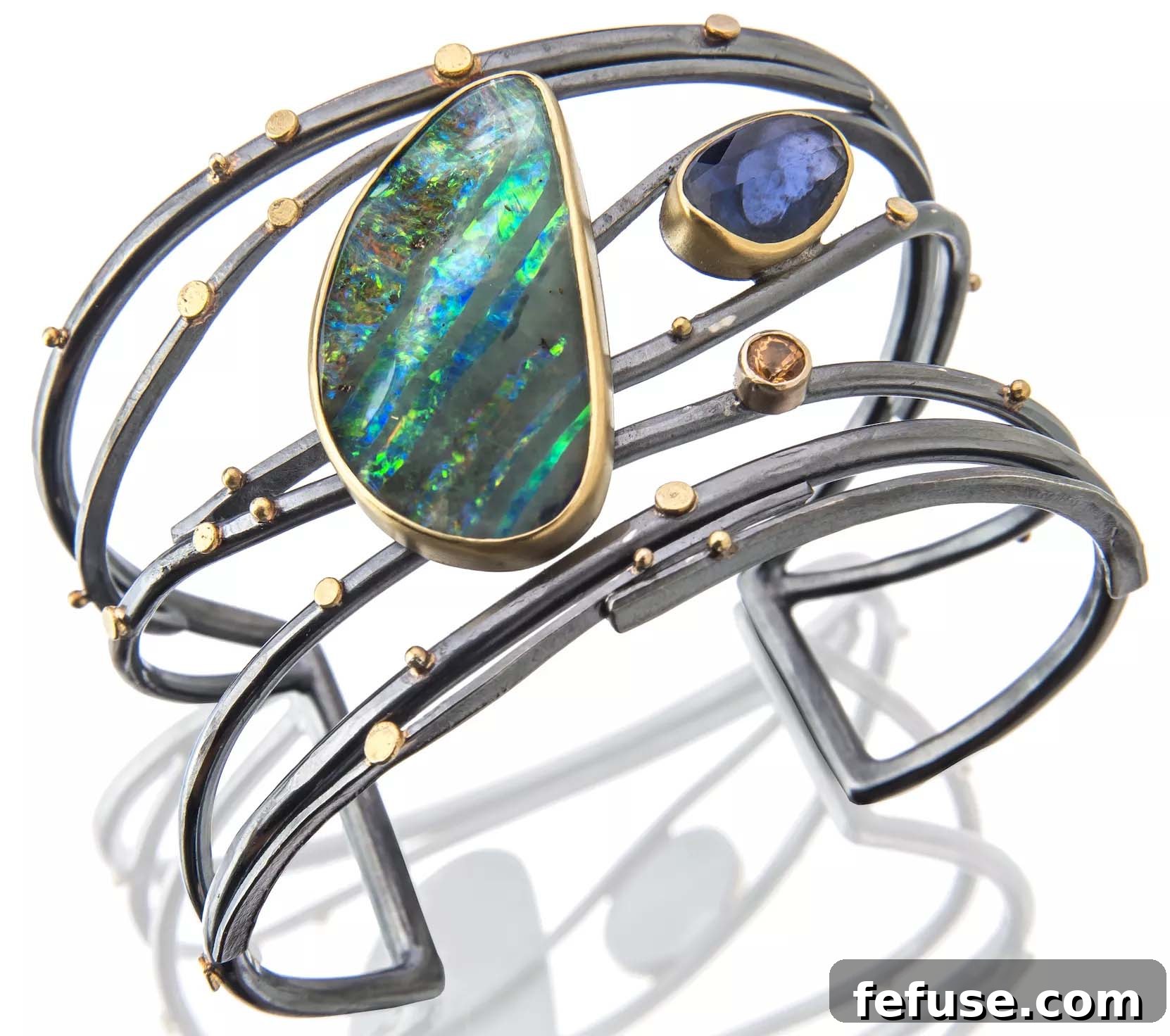 Twig cuff with boulder opal, rose-cut sapphire, and spessartite garnet by Sydney Lynch