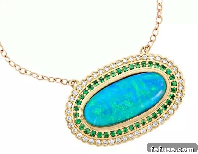 Oval pendant with fire crystal opal, tsavorites, and diamonds in 18k yellow gold by Terry Snider