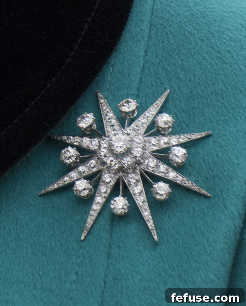 Queen Elizabeth II with the elegant Jardine Star Brooch during a visit to HMS Sutherland in London, October 23, 2017.